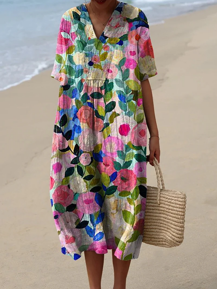 Kleurrijke zomerjurk met bloemenprint, lichte elegantie, knielengte, luchtige stof, ideaal voor warme dagen en zomerse evenementen.