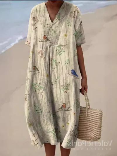 Kleurrijke zomerjurk met bloemenprint, lichte elegantie, knielengte, luchtige stof, ideaal voor warme dagen en zomerse evenementen.