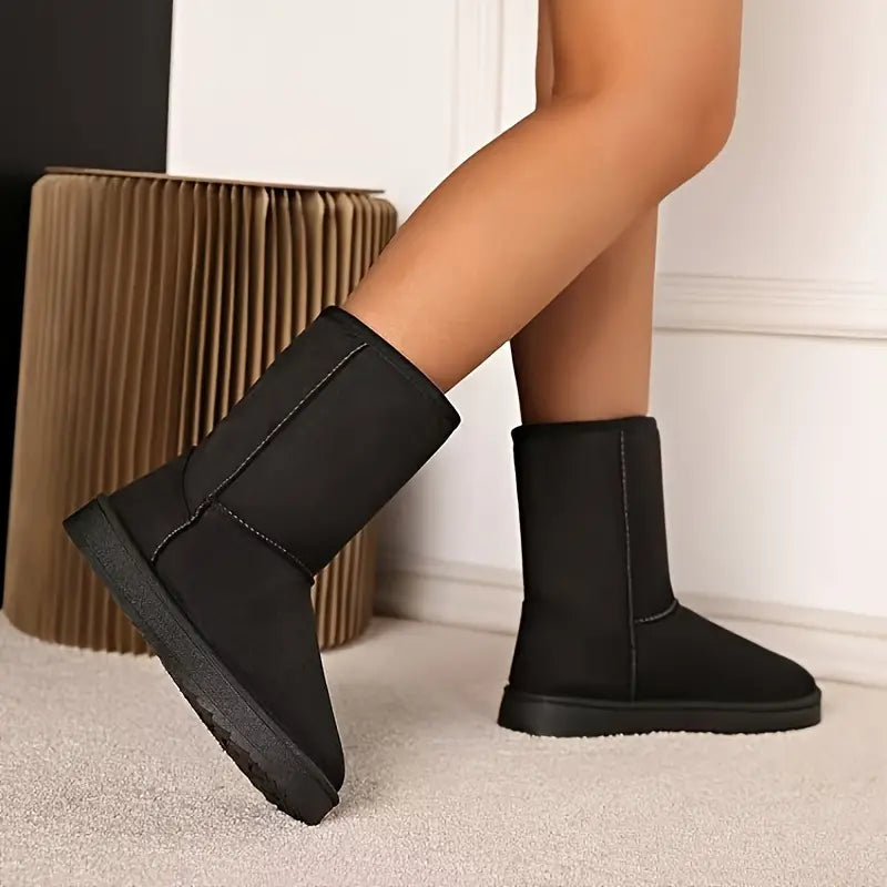 Elegante zwarte Aria casual dames slip-on laarzen. Warm, comfortabel en modieus voor de koude winter.