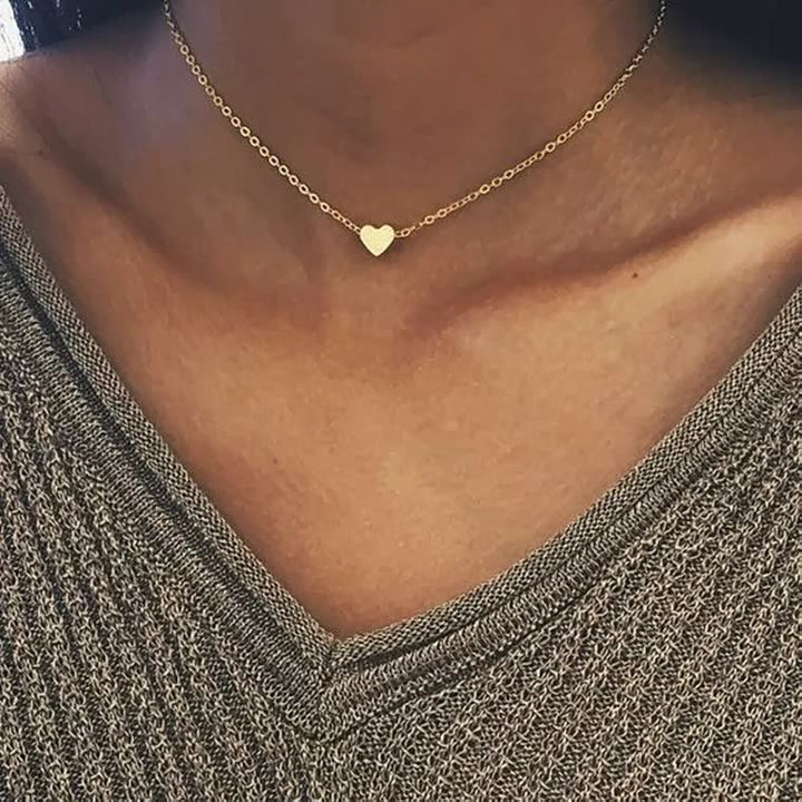 Schuin aanzicht van glanzende zilveren dames ketting. Elegant hartje sieraad, perfect voor modebewuste vrouwen.