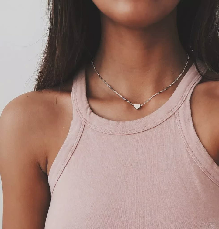 Close-up van ExquisiteChain™ ketting. Fijne schakel met klein glanzend hartje, subtiel dames sieraad.