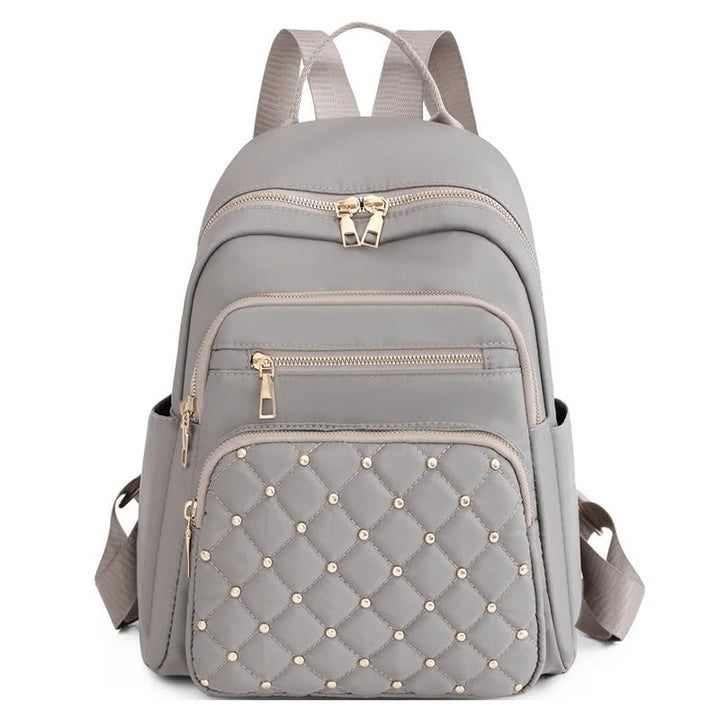 Zwarte waterafstotende damesrugzak van nylon, lichtgewicht schooltas en dagrugzak voor reizen.