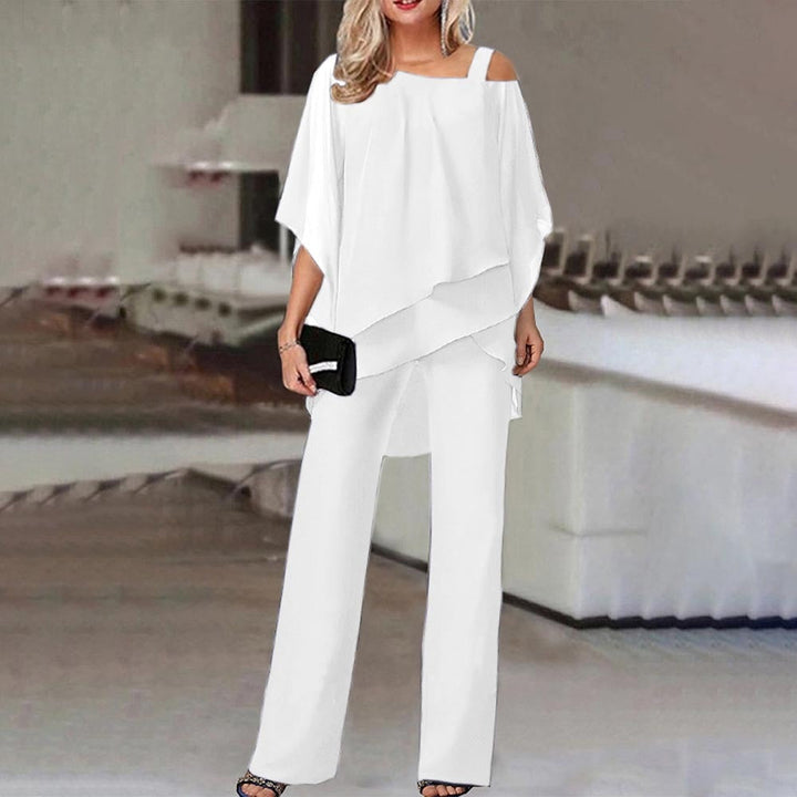 Veelzijdige dames tweedelige set: elegante cold-shoulder top en comfortabele broek, perfect voor dagelijks of feestelijk.