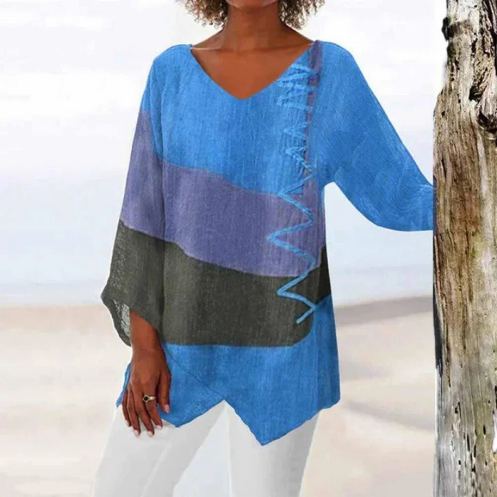 Driekleurige damesblouse met lange mouwen in blauw, geel, rood, achteraanzicht, elegant design, ideaal voor een zomerse look.