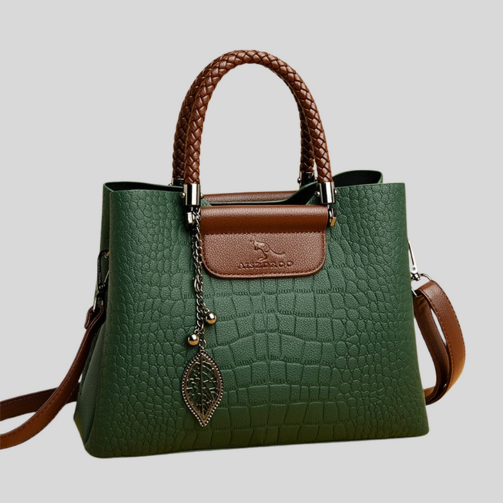 Elegante dameshandtas van leer met verstelbare riem, klassieke vorm, verkrijgbaar in groen en zwart.