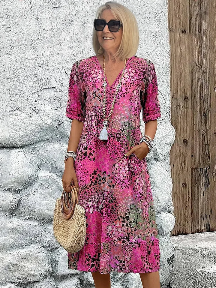 Dames A-lijn midi jurk met V-hals en bloemenprint. Elegante pasvorm, perfect voor diverse gelegenheden.