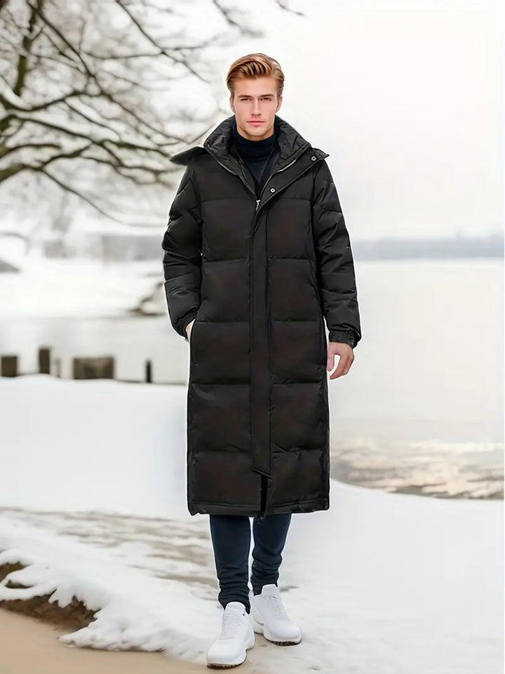 Elegante lange gewatteerde winterjas voor heren met gewatteerd design en optimale weerbescherming voor koude dagen.