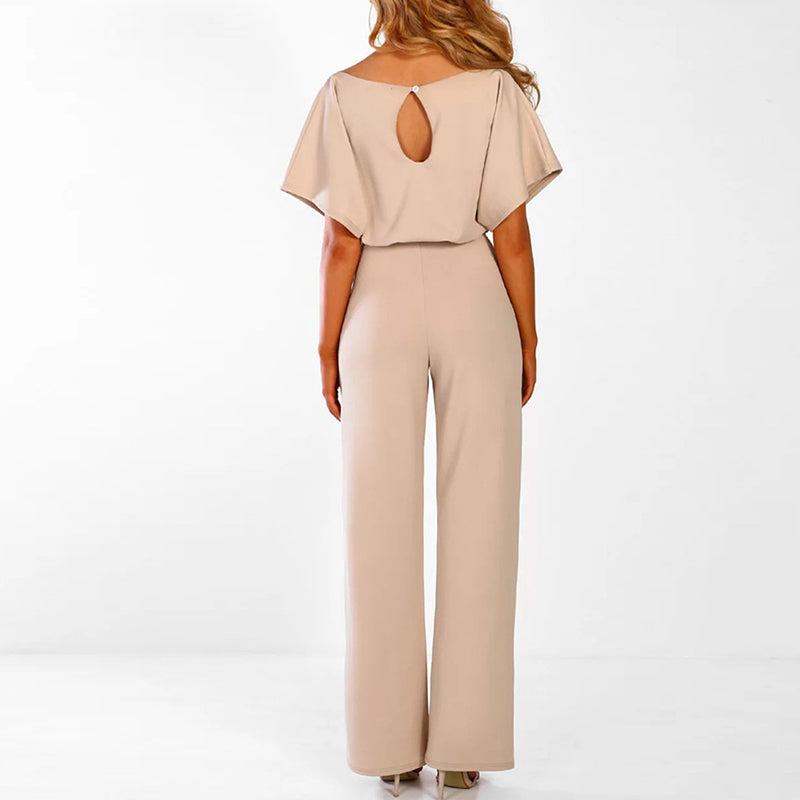 Elegante damesjumpsuit in beige, zwart en roze, met ceintuur en vloeiend silhouet, ideaal voor de zomer.