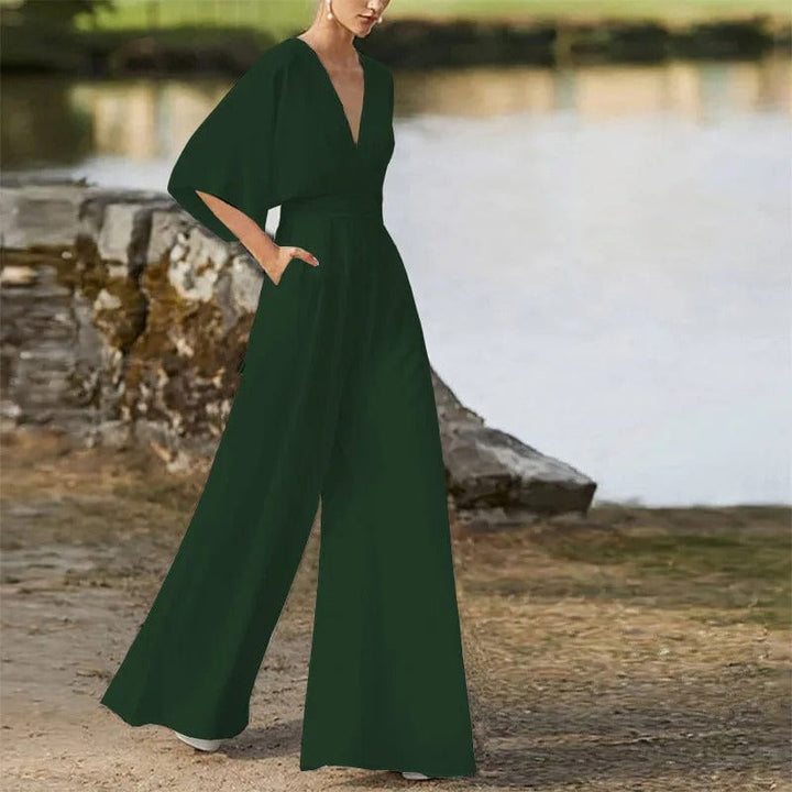Elegant damesjumpsuit met V-hals, dolmanmouwen, elastische tailleband en wijde pijpen in zwart en bordeauxrood.