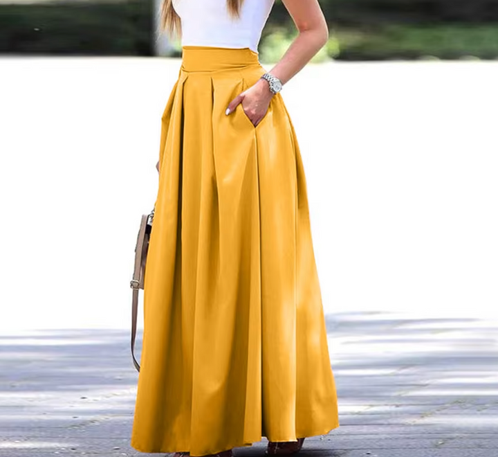 Elegante geplooide maxi-rok voor dames, vloeibaar, licht en met A-lijn, veelzijdig te combineren, ideaal voor chique gelegenheden.