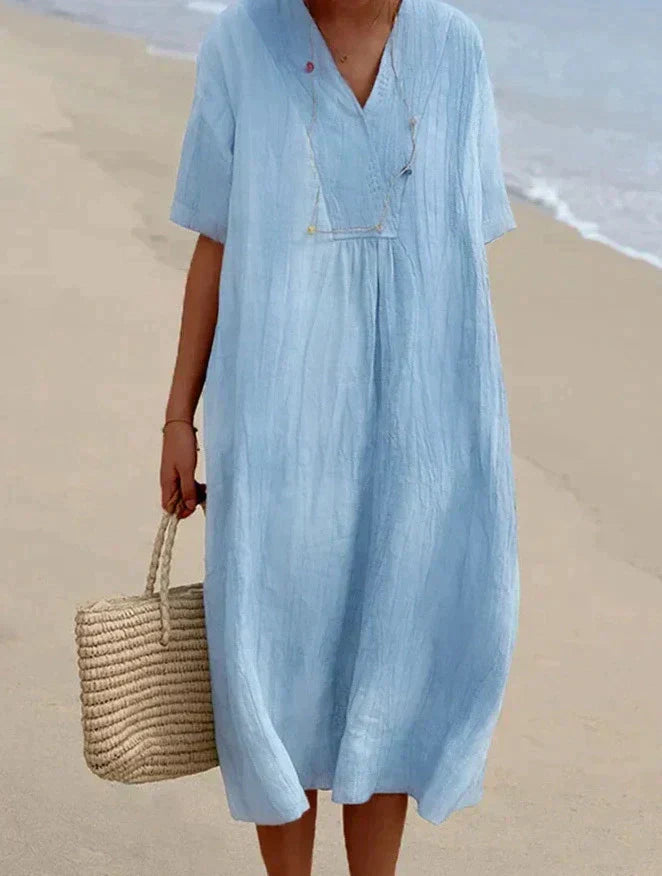 Elegante lichtblauwe zomerjurk van katoen-linnen, V-hals, A-lijn, met strandtas, perfecte zomerse elegantie.