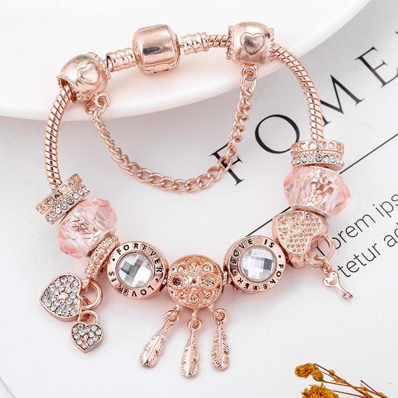 Elegant sterling zilveren armband met roze kristallen en hartvormige bedels, handgemaakt, symboliseert bescherming en elegantie.