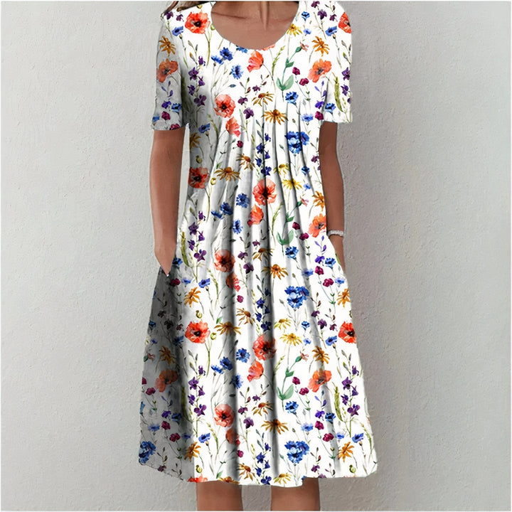 Elegant wit katoenen zomerjurk voor dames, knielengte en soepel vallend, ideaal voor elegante zomerse gelegenheden.