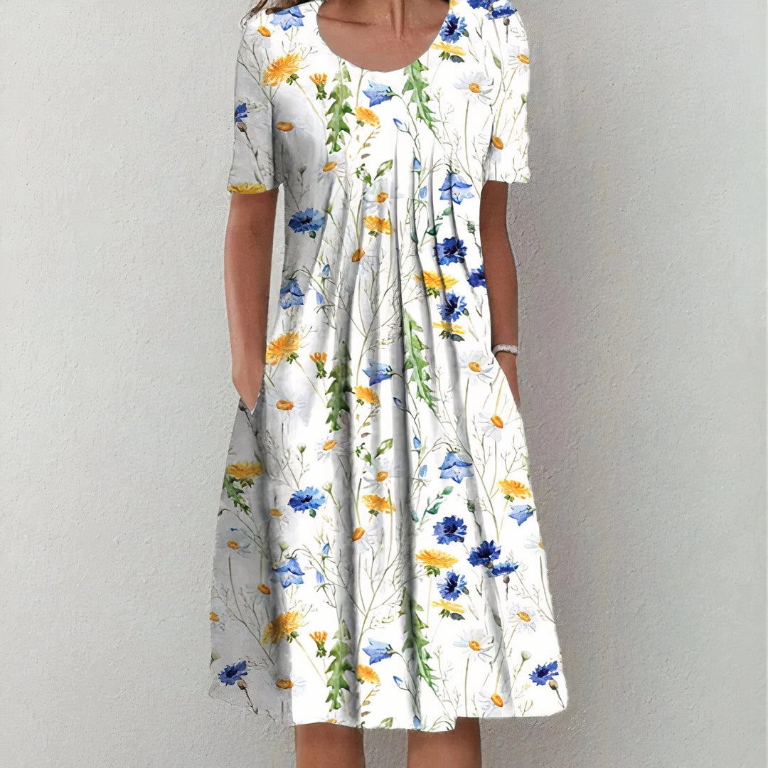Elegant wit katoenen zomerjurk voor dames, knielengte en soepel vallend, ideaal voor elegante zomerse gelegenheden.