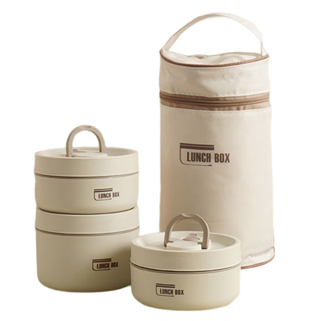 De Isobox geïsoleerde lunchbox staat op tafel, open, met diverse etenswaren, naast de draagtas.