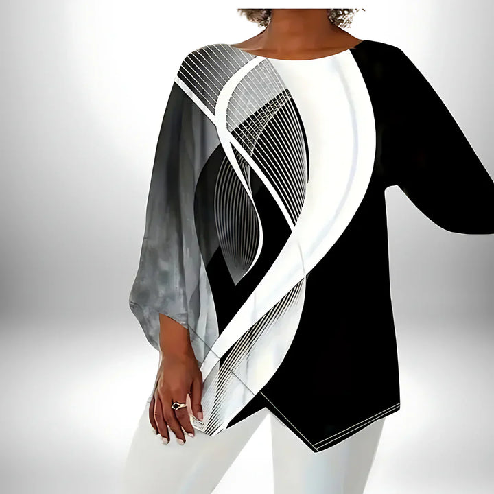 Zwart-wit geometrische damestop met lange mouwen, asymmetrische zoom, veelzijdig te combineren voor elegante en modieuze looks.
