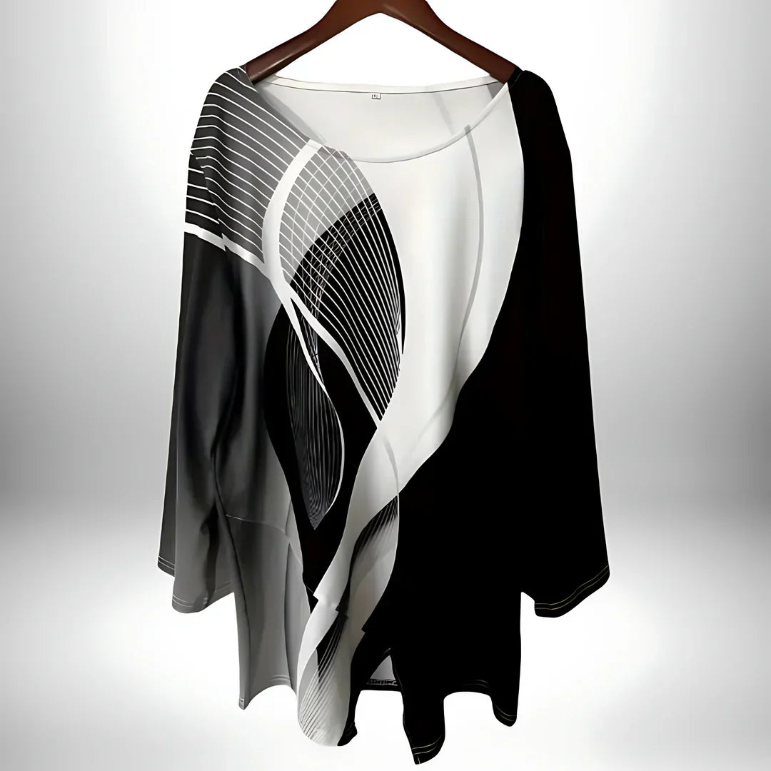 Zwart-wit geometrische damestop met lange mouwen, asymmetrische zoom, veelzijdig te combineren voor elegante en modieuze looks.
