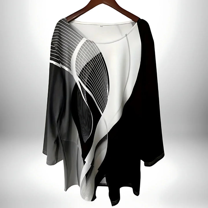 Zwart-wit geometrische damestop met lange mouwen, asymmetrische zoom, veelzijdig te combineren voor elegante en modieuze looks.