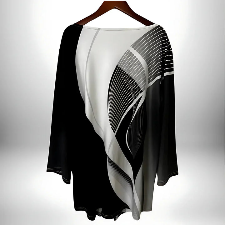 Zwart-wit geometrische damestop met lange mouwen, asymmetrische zoom, veelzijdig te combineren voor elegante en modieuze looks.