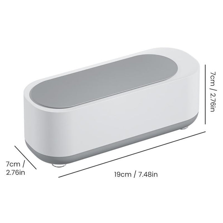 Compact ultrasoon reinigingsapparaat in wit en grijs voor sieraden, brillen, horloges; efficiënte 360°-dieptereiniging.