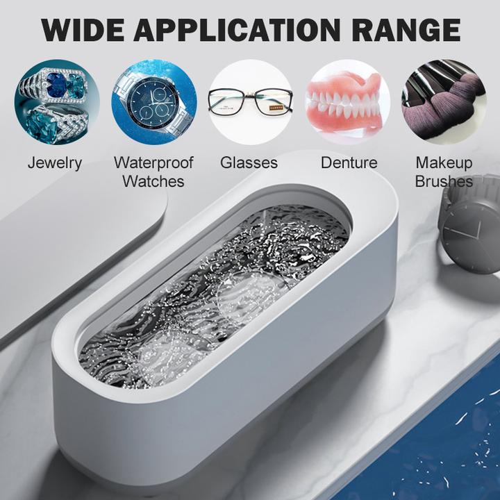 Compact ultrasoon reinigingsapparaat in wit en grijs voor sieraden, brillen, horloges; efficiënte 360°-dieptereiniging.