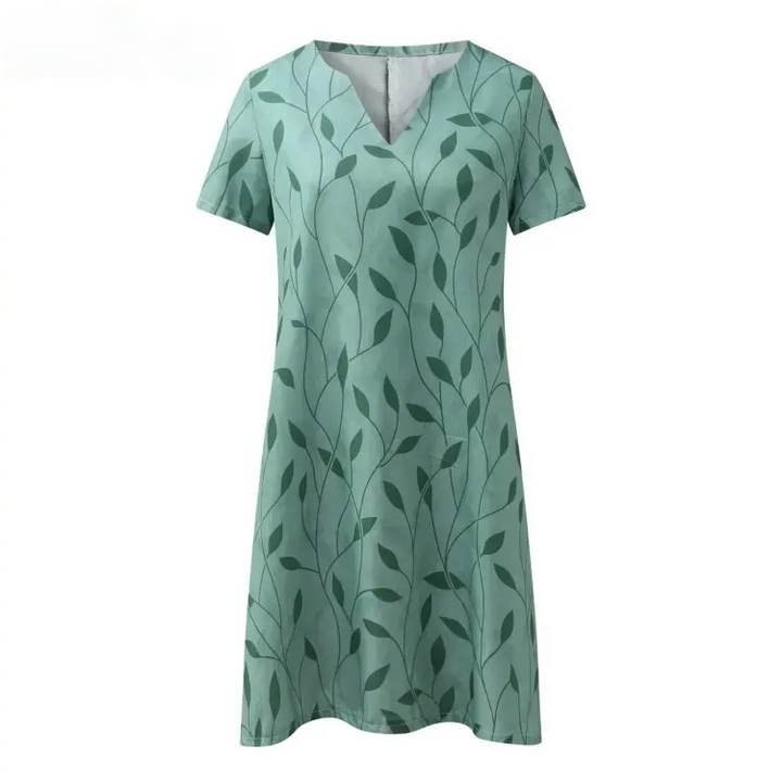 Luchtige zomer mini damesjurk met korte mouwen en bladmotief, verkrijgbaar in groen en wit, ideaal voor warme dagen en avonden.