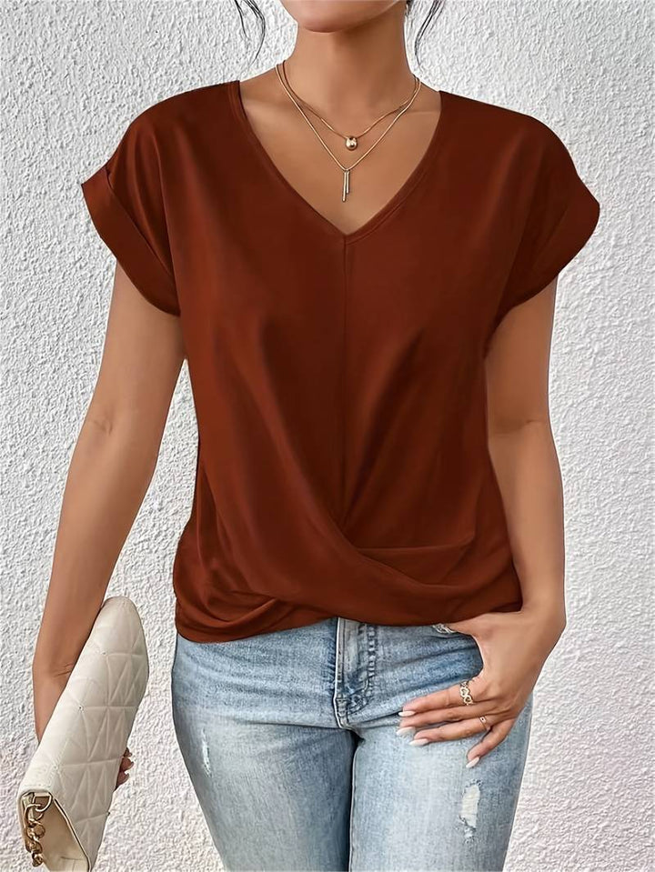 Lichtgewicht damesshirt met V-hals en gedraaide detail, comfortabele pasvorm, perfect voor diverse gelegenheden.