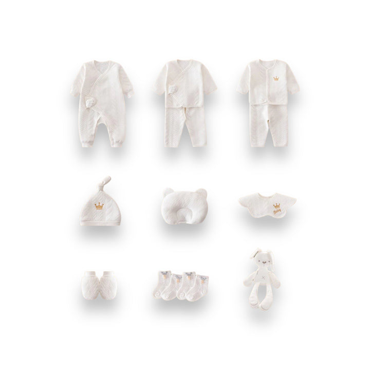 Luxe geschenkset voor pasgeborenen met zachte rompertjes, knusse dekens en schattige accessoires in pastelkleuren.