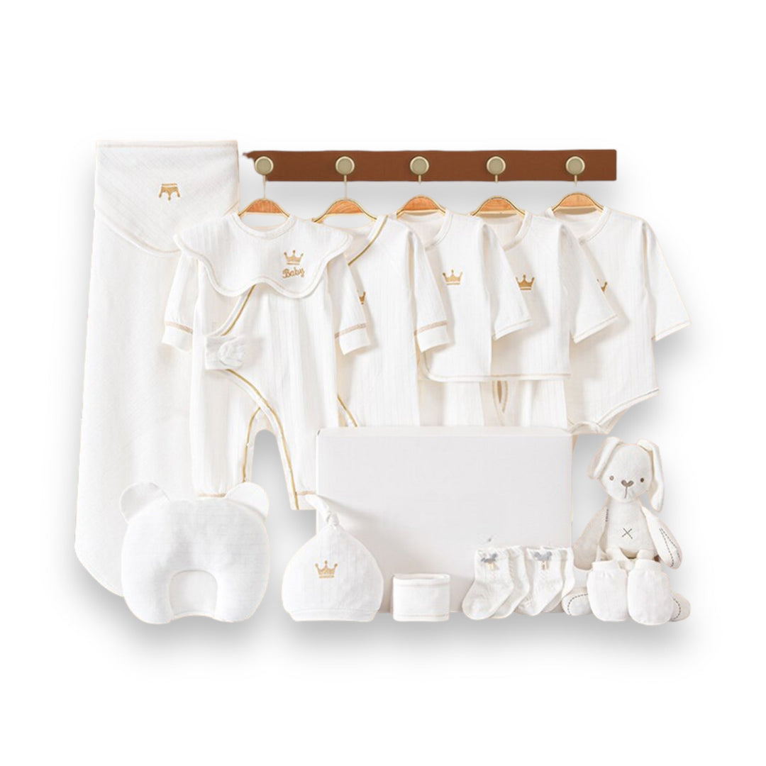 Luxe geschenkset voor pasgeborenen met zachte rompertjes, knusse dekens en schattige accessoires in pastelkleuren.