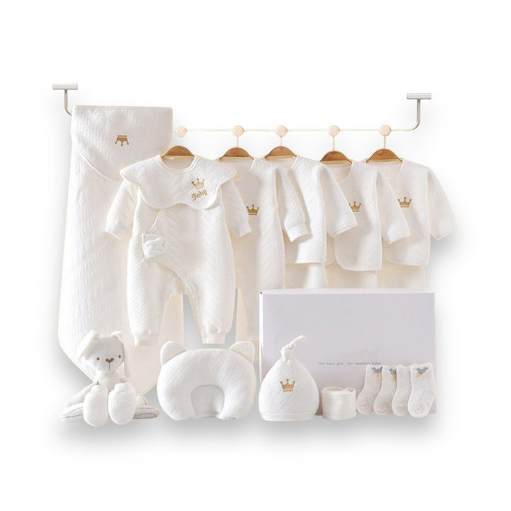Luxe geschenkset voor pasgeborenen met zachte rompertjes, knusse dekens en schattige accessoires in pastelkleuren.