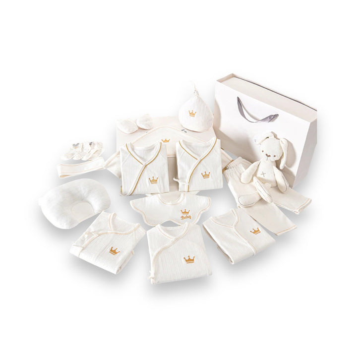 Luxe geschenkset voor pasgeborenen met zachte rompertjes, knusse dekens en schattige accessoires in pastelkleuren.
