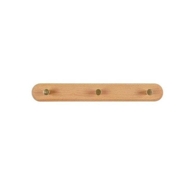 Moderne LignaHook houten wandkapstok, gezien vanuit een interieurhoek. Strak design met messing accenten.