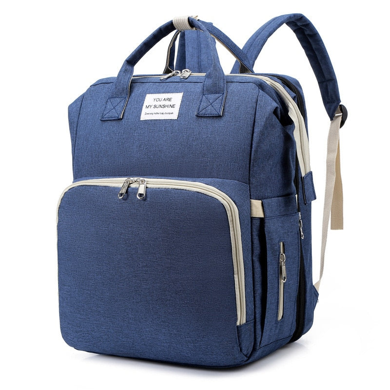 Ouders reizen comfortabel met deze 2-in-1 luiertas en draagbaar babybed. Makkelijk mee te nemen.