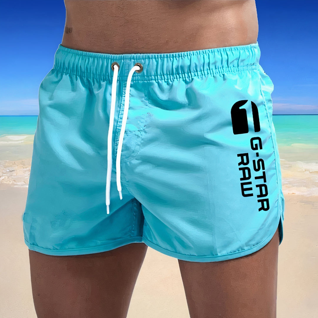 Sneldrogende blauwe heren zwembroek, stijlvol design, elastische tailleband, ideaal voor strand en zwembad.
