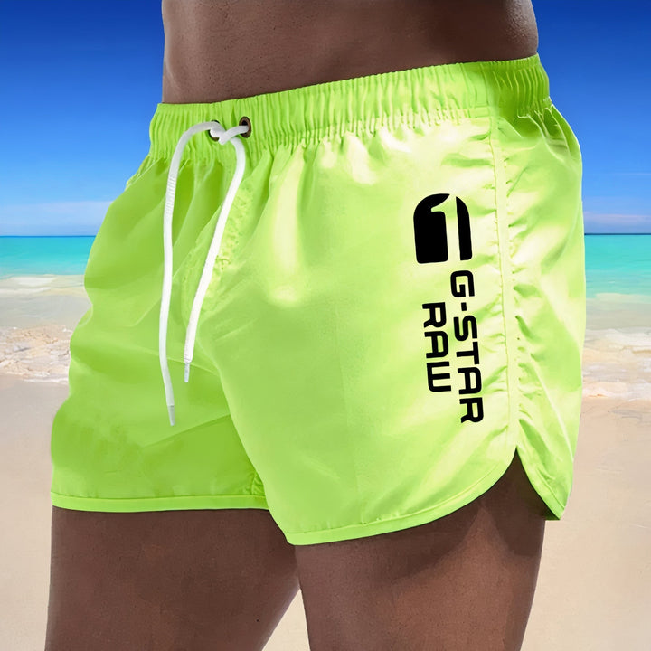 Sneldrogende blauwe heren zwembroek, stijlvol design, elastische tailleband, ideaal voor strand en zwembad.