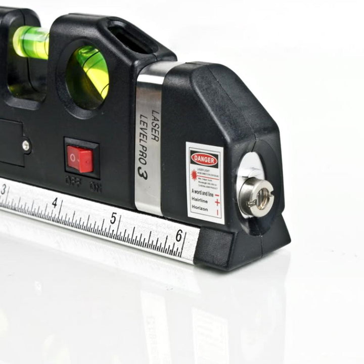 Zwarte multifunctionele laser waterpas met meetlint, libel en laserstraal op een houten achtergrond.