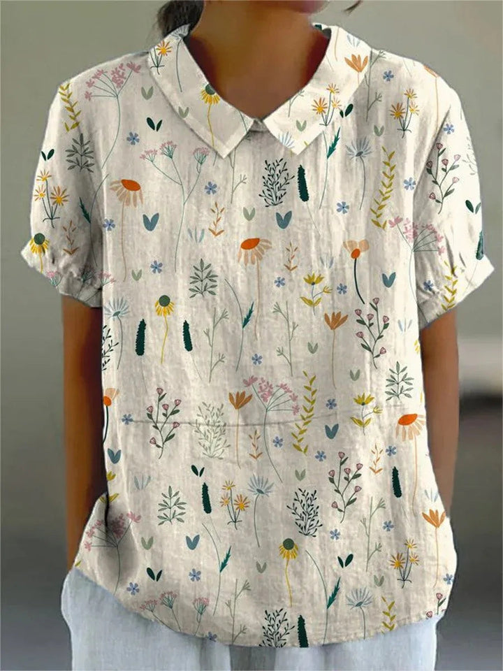 Zomerblouse met wilde bloemenprint, pastelkleurig, losvallend, ideaal voor warme dagen; damesmode, stijlvol en comfortabel.