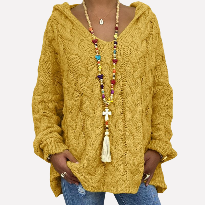 Relaxte oversized dames trui met v-hals en kabelpatroon. Perfect als casual bovenkleding voor koude herfst- en winterdagen.