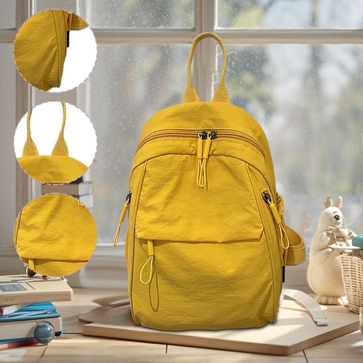 Detailfoto van de waterdichte ritssluitingen op de gele casual schooltas met veel vakken.