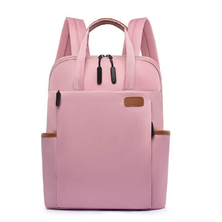 Roze antidiefstal rugzak voor vrouwen, compact en veilig voor dagelijks gebruik of reizen.