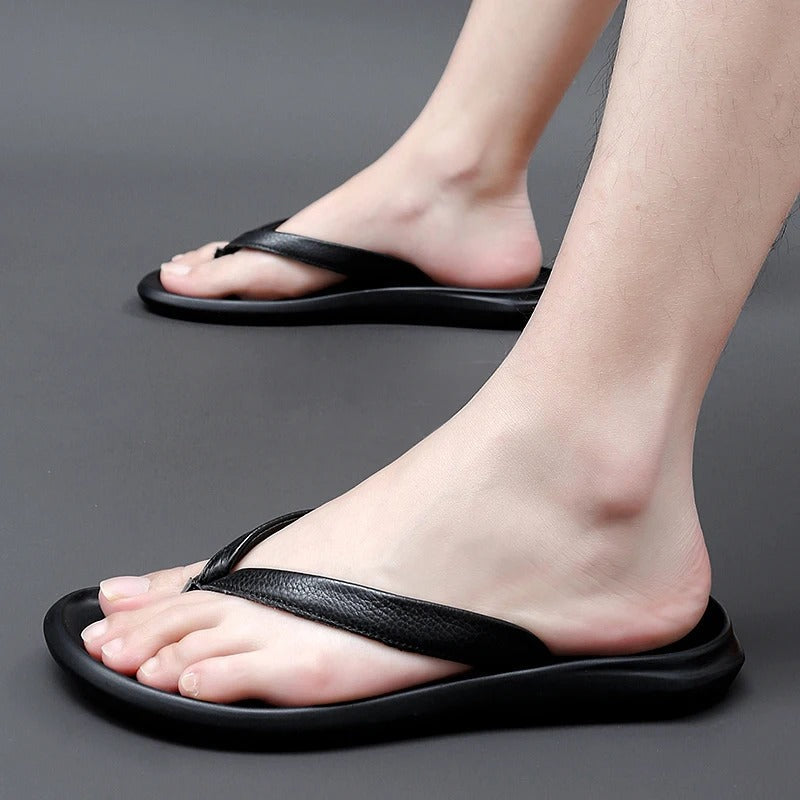 Paar stijlvolle Dario herenslippers in zwart, klaar voor een zomerse dag, antislip design.