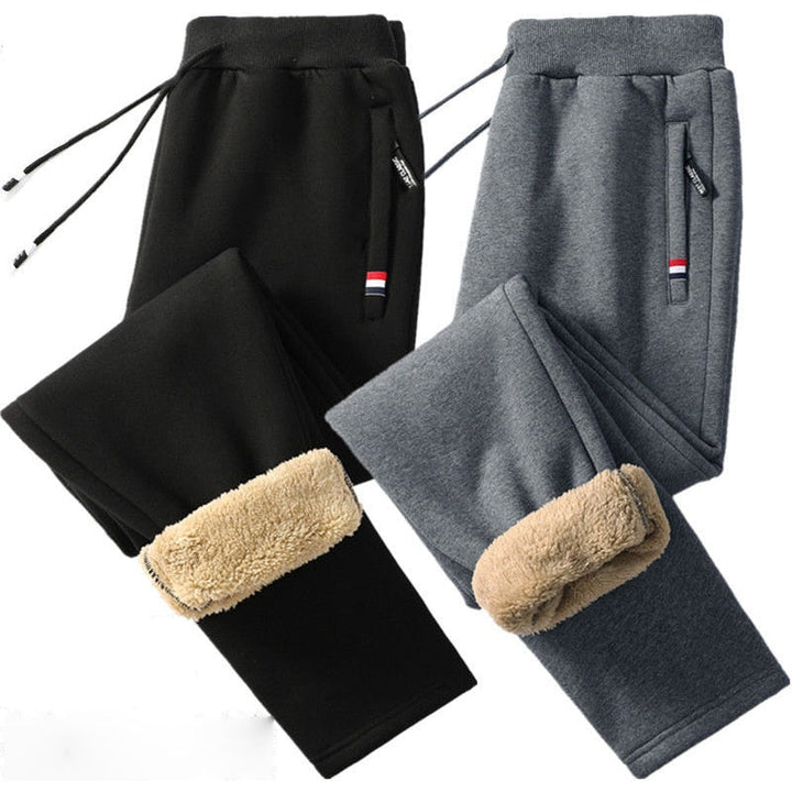 Achterkant grijze heren thermobroek. Warme winterkleding met elastische taille, ideaal voor sport en casual gebruik.